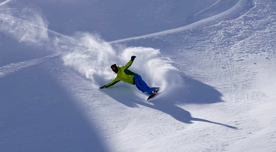 a person snowboarding down a slope