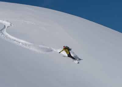 a person skiing down a snowy hill